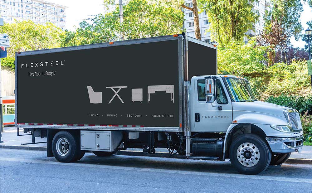 Box truck with Flexsteel logo and line art of furniture on the side of it.